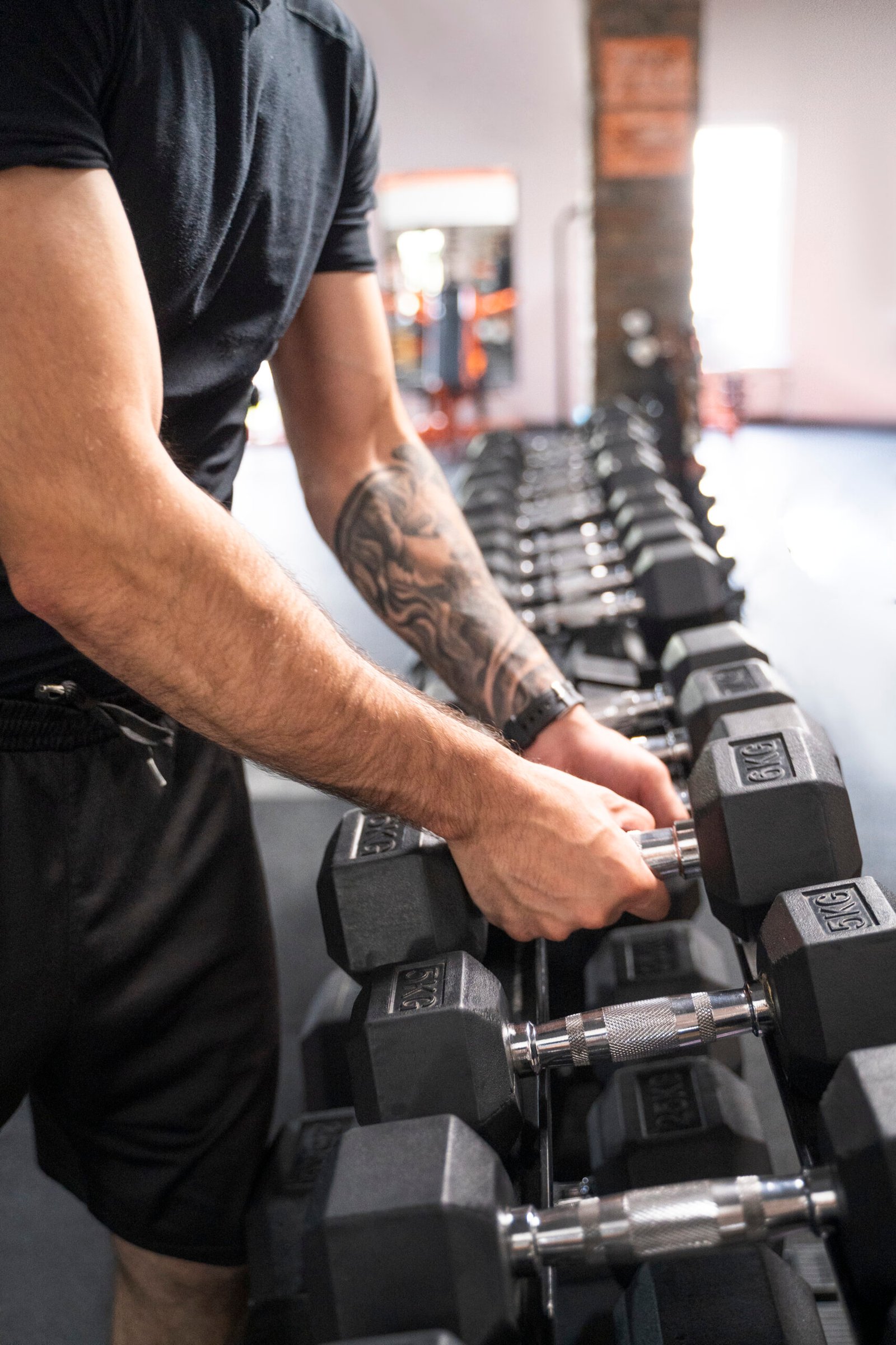 side view man holding dumbbells